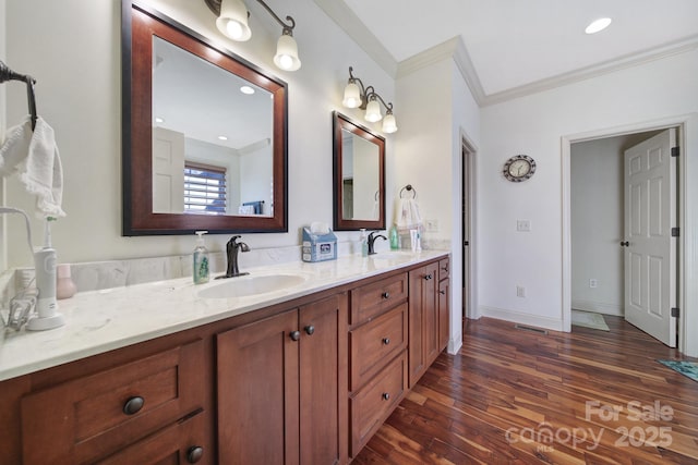 bathroom with hardwood / wood-style flooring, vanity, and ornamental molding