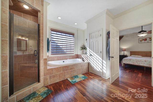 bathroom featuring plus walk in shower, hardwood / wood-style floors, ceiling fan, and ornamental molding