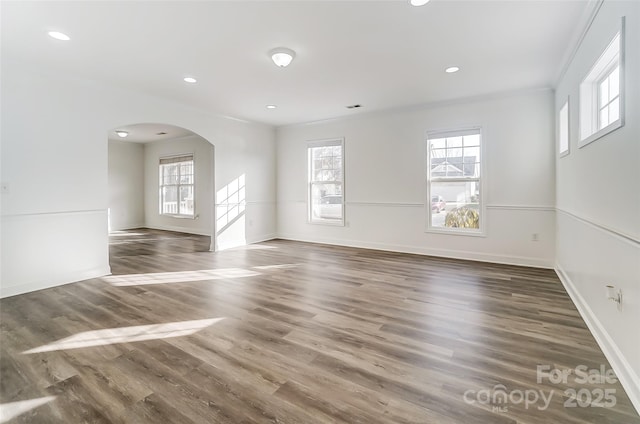 empty room featuring dark hardwood / wood-style flooring and crown molding