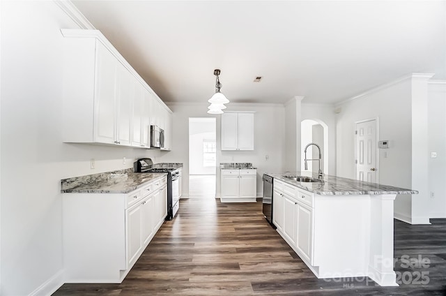 kitchen with appliances with stainless steel finishes, sink, decorative light fixtures, a center island with sink, and white cabinetry