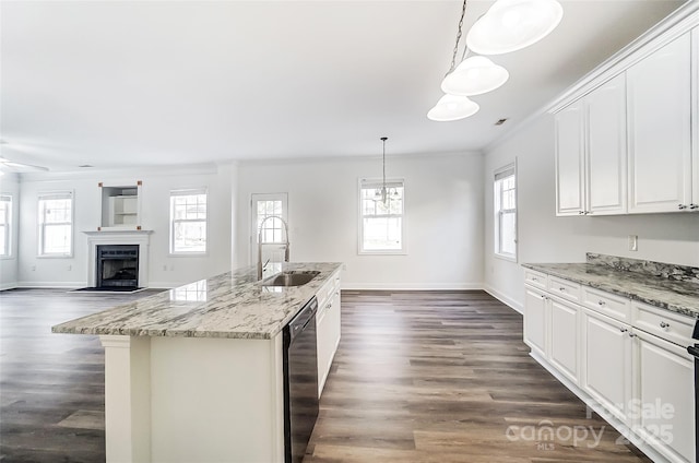 kitchen with dishwasher, a kitchen island with sink, hanging light fixtures, sink, and white cabinetry