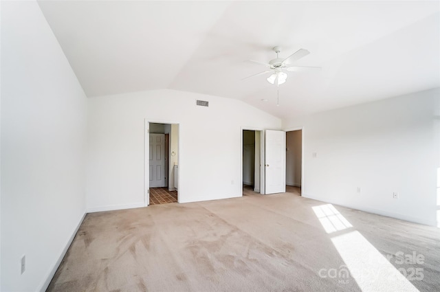 unfurnished bedroom featuring ceiling fan, light colored carpet, and vaulted ceiling