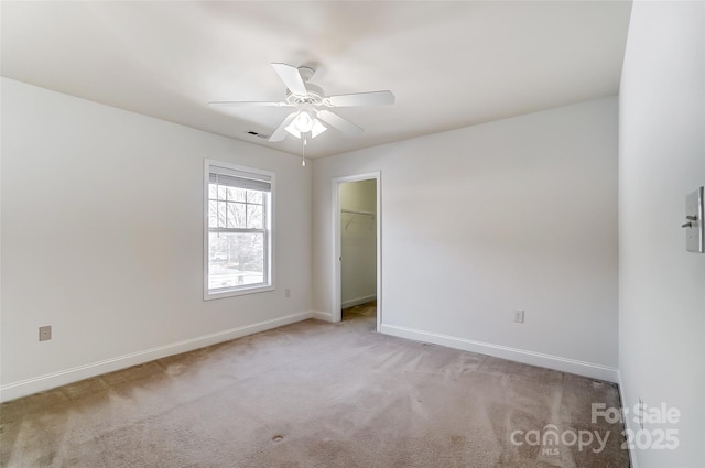 unfurnished room featuring light colored carpet and ceiling fan