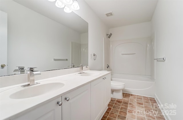 full bathroom featuring washtub / shower combination, vanity, and toilet