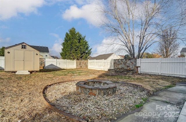 view of yard with a fire pit and a storage shed