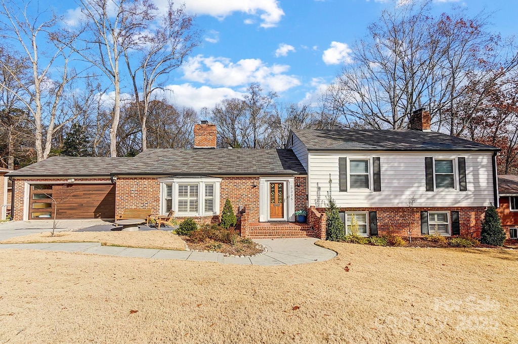 view of front facade with a front lawn and a garage