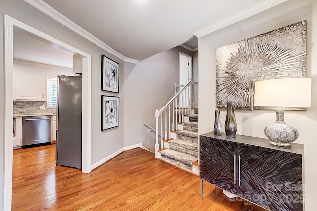 hallway featuring light hardwood / wood-style flooring and crown molding