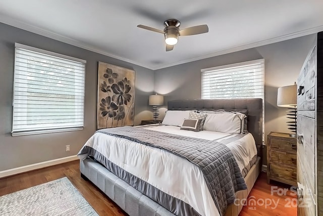 bedroom with ceiling fan, ornamental molding, and dark hardwood / wood-style floors