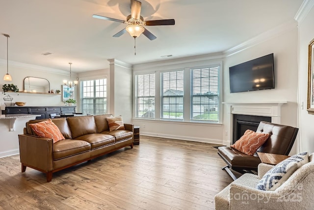 living room featuring hardwood / wood-style flooring, a wealth of natural light, and crown molding