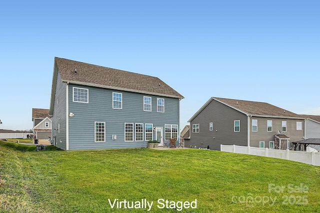 rear view of house with a patio area and a yard