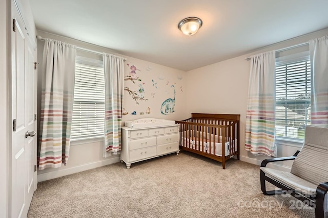 carpeted bedroom with a crib