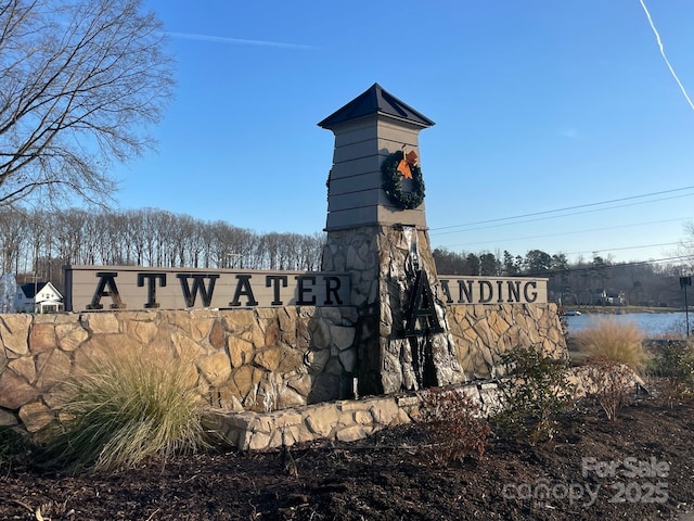 community / neighborhood sign with a water view