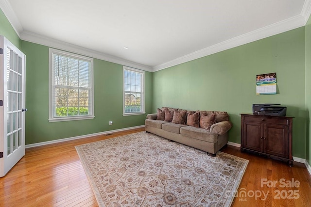 living room featuring light hardwood / wood-style floors and ornamental molding