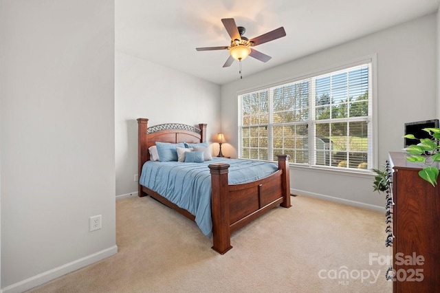 bedroom with ceiling fan and light carpet