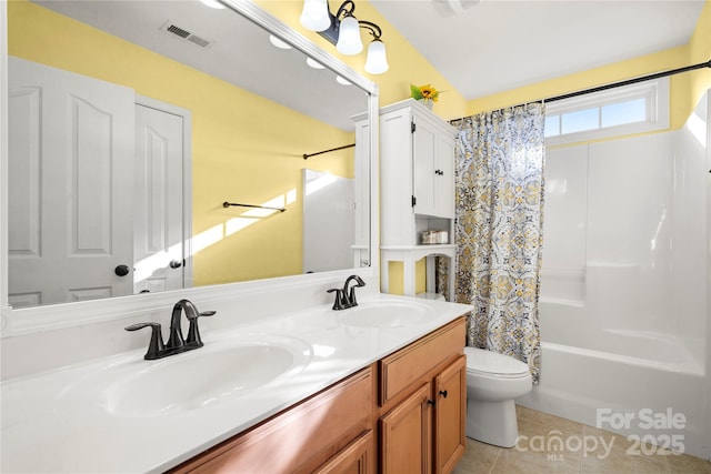 full bathroom featuring tile patterned floors, vanity, shower / bath combination with curtain, and toilet