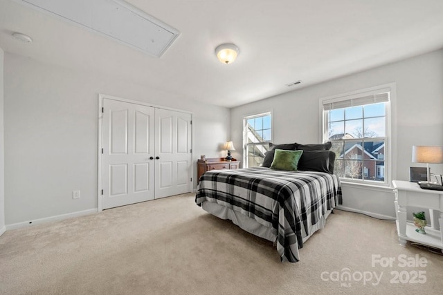 bedroom featuring light carpet and a closet