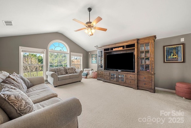 carpeted living room featuring ceiling fan and vaulted ceiling