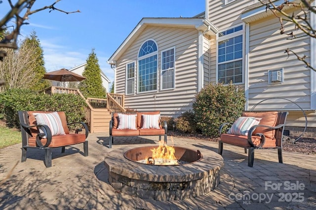 view of patio with a fire pit and a wooden deck