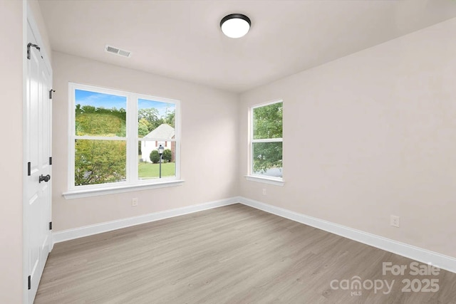 unfurnished room with light hardwood / wood-style flooring