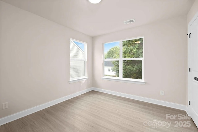 unfurnished room with light hardwood / wood-style floors