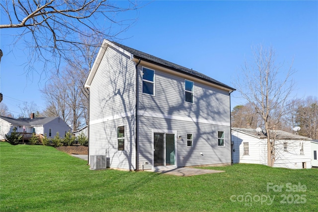 rear view of property with a lawn and cooling unit