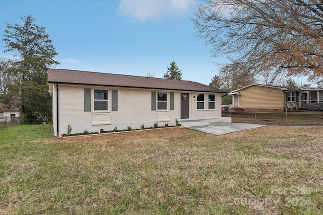 single story home with a patio area and a front yard