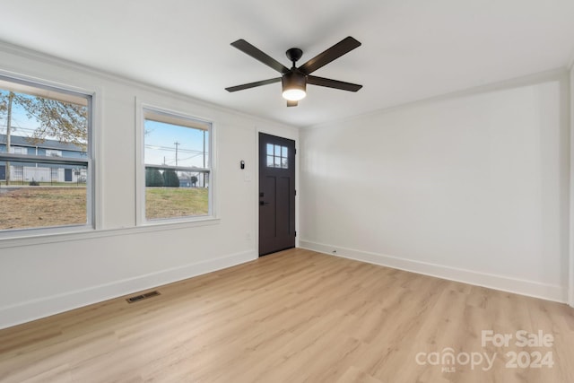 foyer with light hardwood / wood-style floors and ceiling fan