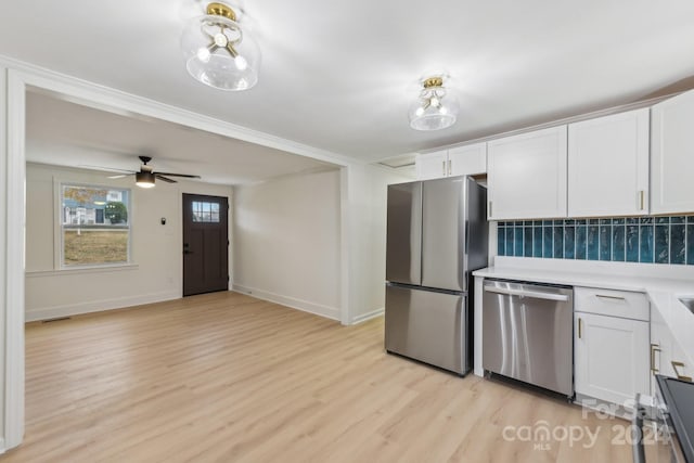 kitchen with white cabinetry, ceiling fan, stainless steel appliances, tasteful backsplash, and light hardwood / wood-style floors