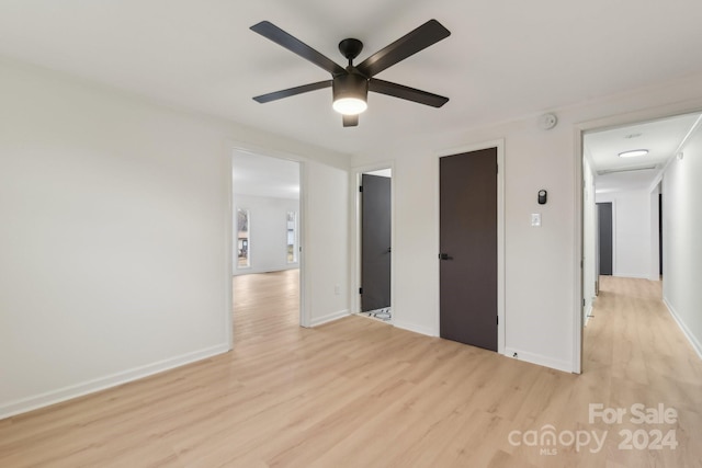 empty room featuring ceiling fan and light wood-type flooring