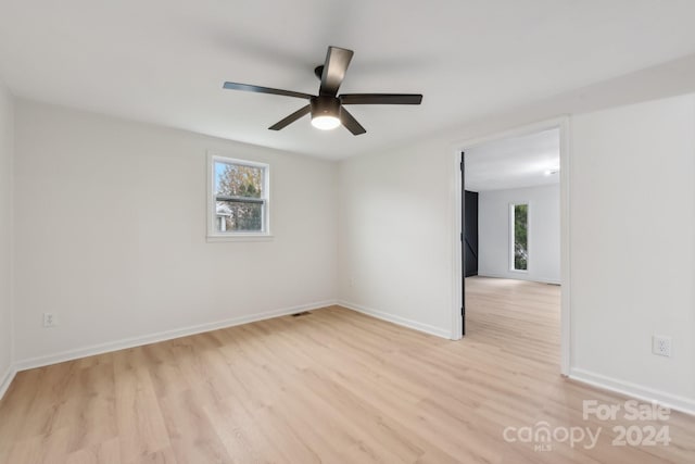 unfurnished room featuring ceiling fan and light wood-type flooring