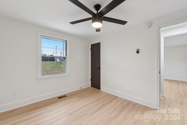 unfurnished bedroom featuring ceiling fan and light wood-type flooring