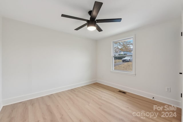 empty room with ceiling fan and light wood-type flooring