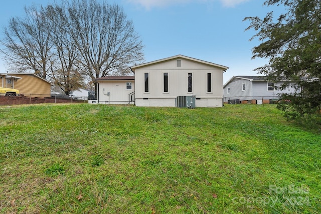 back of house with central AC unit