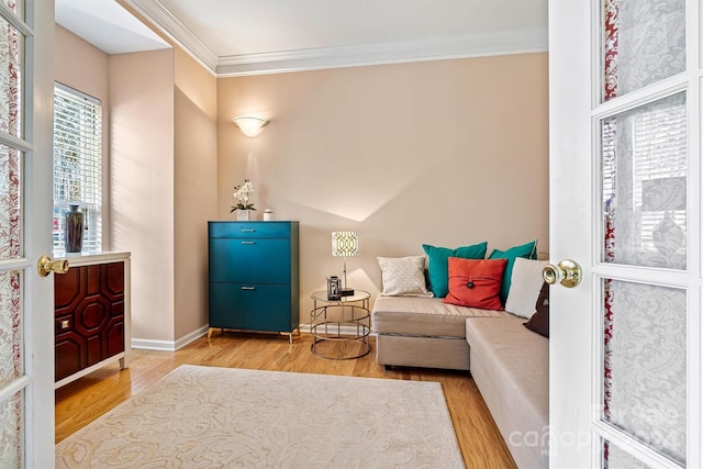 sitting room featuring hardwood / wood-style floors and crown molding