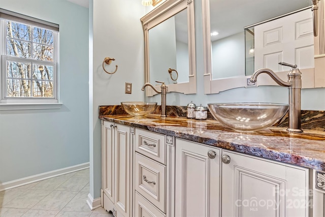 bathroom with tile patterned floors and vanity