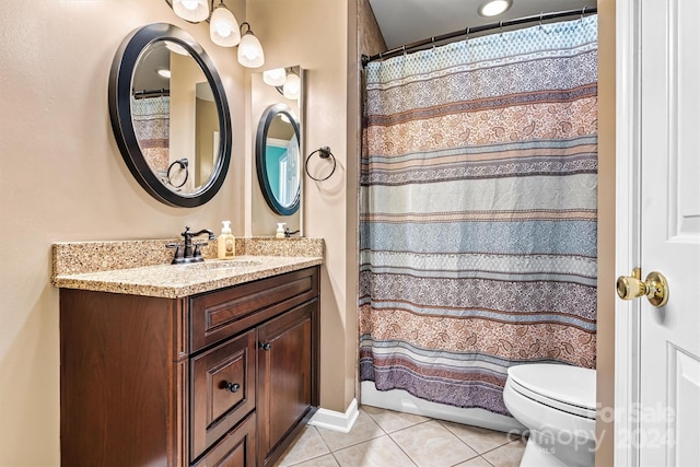 bathroom with tile patterned flooring, vanity, and toilet