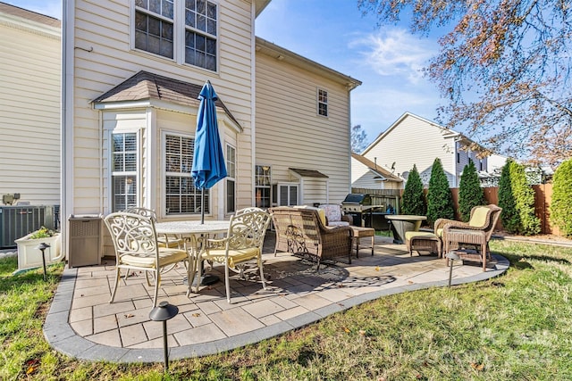 back of house with an outdoor hangout area, a patio area, and central air condition unit