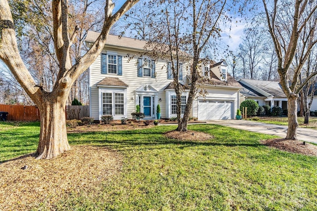 view of front facade with a garage and a front lawn