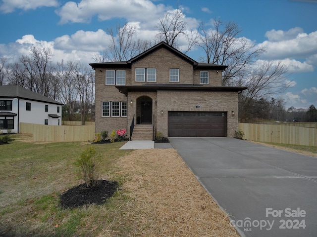 front facade featuring a front yard and a garage