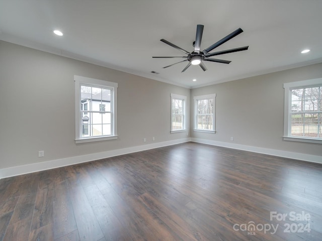 empty room featuring crown molding, ceiling fan, and dark hardwood / wood-style floors