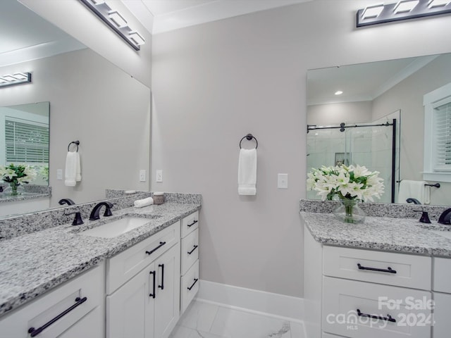 bathroom with vanity, an enclosed shower, and ornamental molding