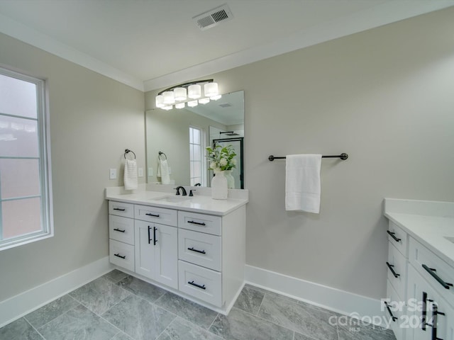 bathroom featuring vanity, plenty of natural light, and crown molding