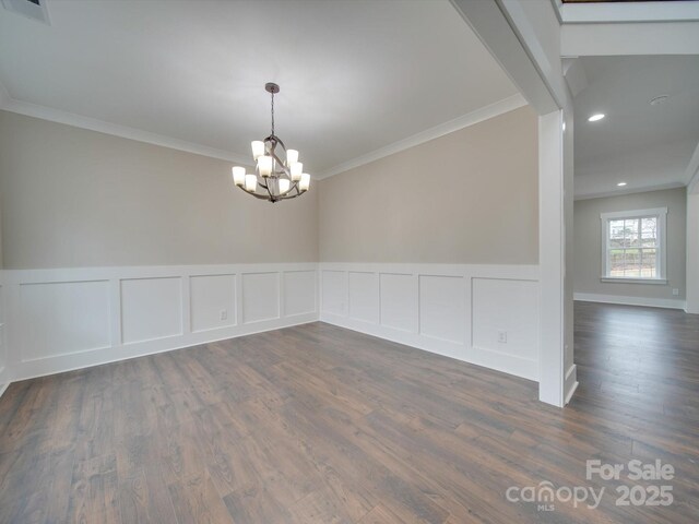 1304 Pleasant Plains Rd, Matthews, NC 28105 - spare room with a chandelier, crown molding, dark wood-style floors, wainscoting, and a decorative wall