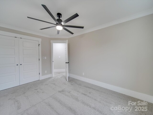1304 Pleasant Plains Rd, Matthews, NC 28105 - unfurnished bedroom featuring ornamental molding, carpet floors, baseboards, ceiling fan, and a closet