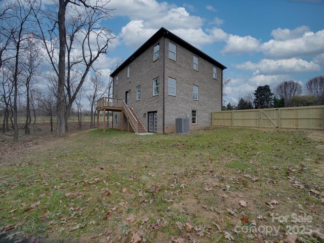 1304 Pleasant Plains Rd, Matthews, NC 28105 - back of house featuring stairway, central AC unit, and a deck