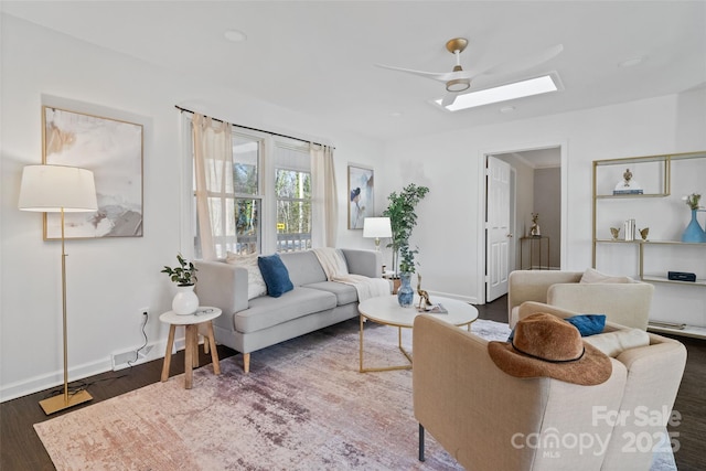 living room with ceiling fan and dark hardwood / wood-style floors