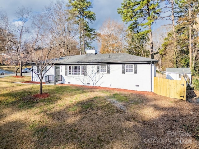 back of property featuring a lawn