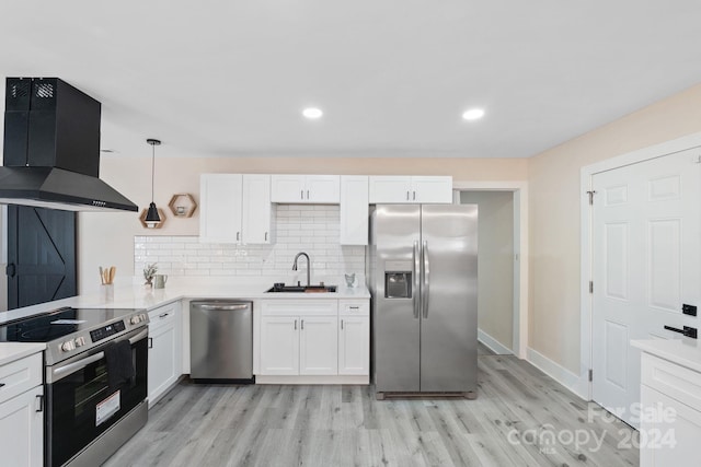 kitchen with pendant lighting, sink, range hood, white cabinetry, and stainless steel appliances