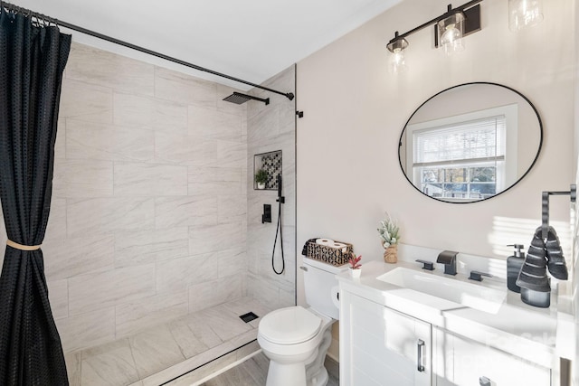 bathroom with hardwood / wood-style floors, vanity, toilet, and walk in shower