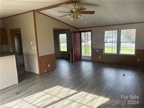 unfurnished living room featuring hardwood / wood-style floors and ceiling fan